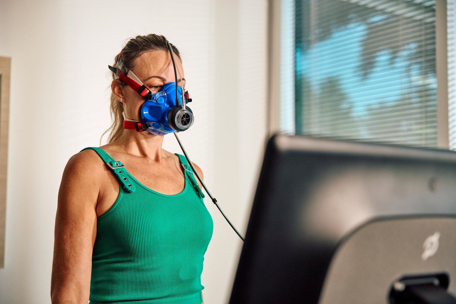 Patient wearing a VO2 mask during treadmill testing
